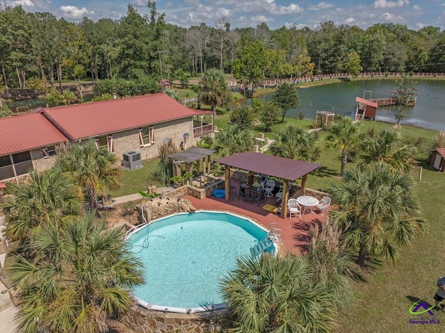 view of swimming pool featuring a water view and central AC unit