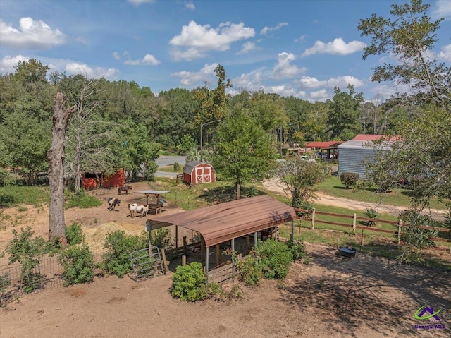 view of yard with a rural view and a shed