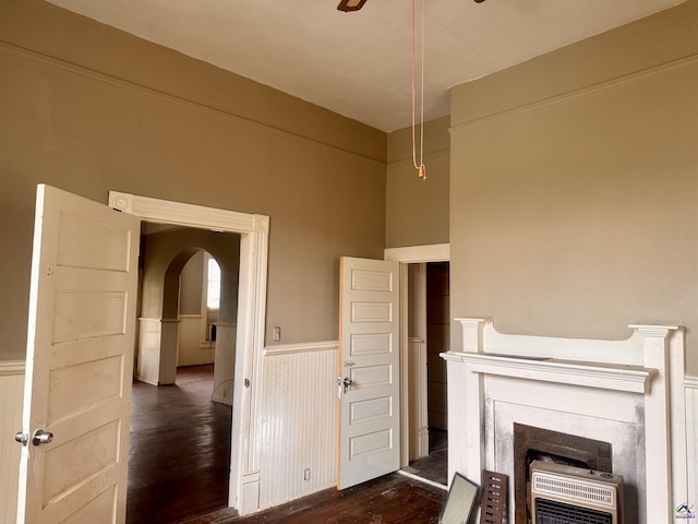 unfurnished living room with dark hardwood / wood-style flooring and heating unit