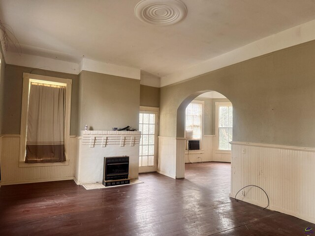 unfurnished living room featuring dark hardwood / wood-style flooring