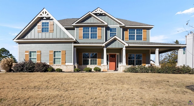 craftsman house with a porch and a front lawn