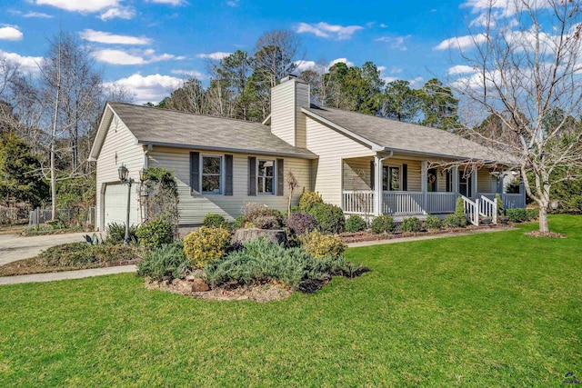 view of front of property featuring covered porch, a garage, and a front yard