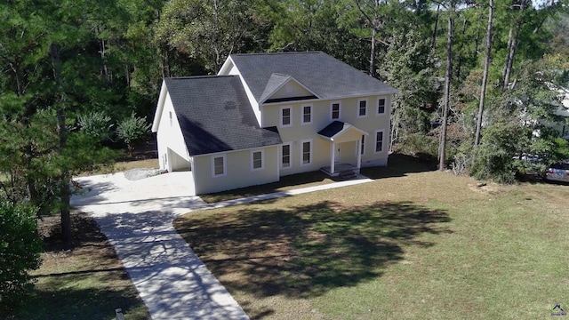 view of front of house with a front lawn and a garage