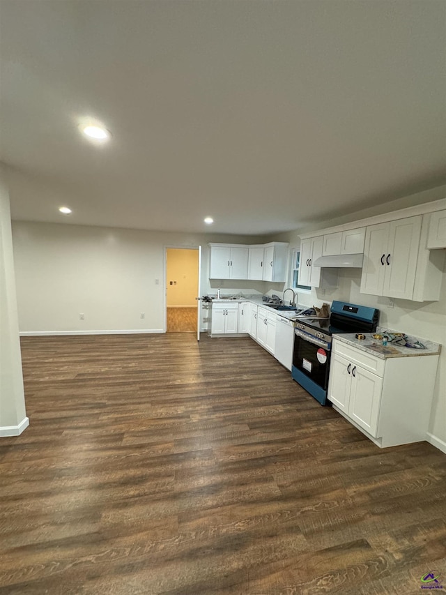 kitchen with dishwasher, sink, dark hardwood / wood-style floors, stainless steel range oven, and white cabinets