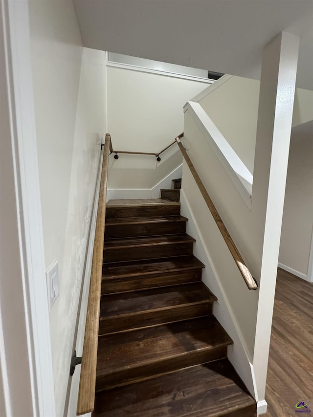 stairway with hardwood / wood-style floors