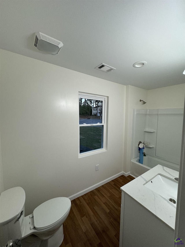 full bathroom featuring hardwood / wood-style flooring, vanity, toilet, and shower / bath combination