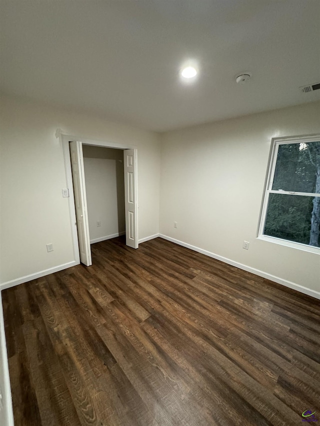 empty room featuring dark wood-type flooring