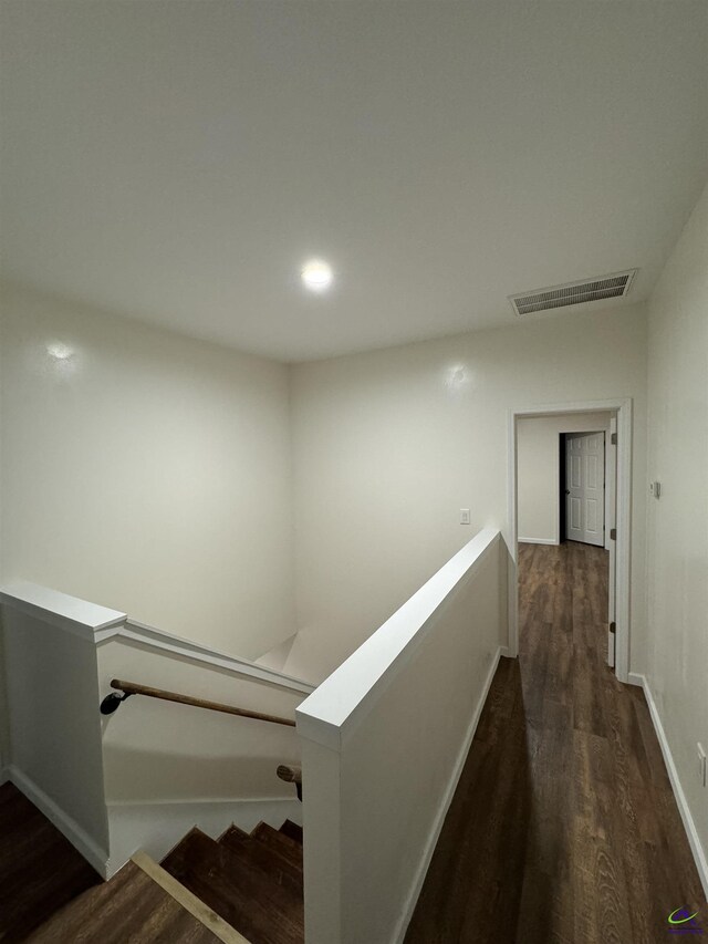 hallway with dark hardwood / wood-style floors