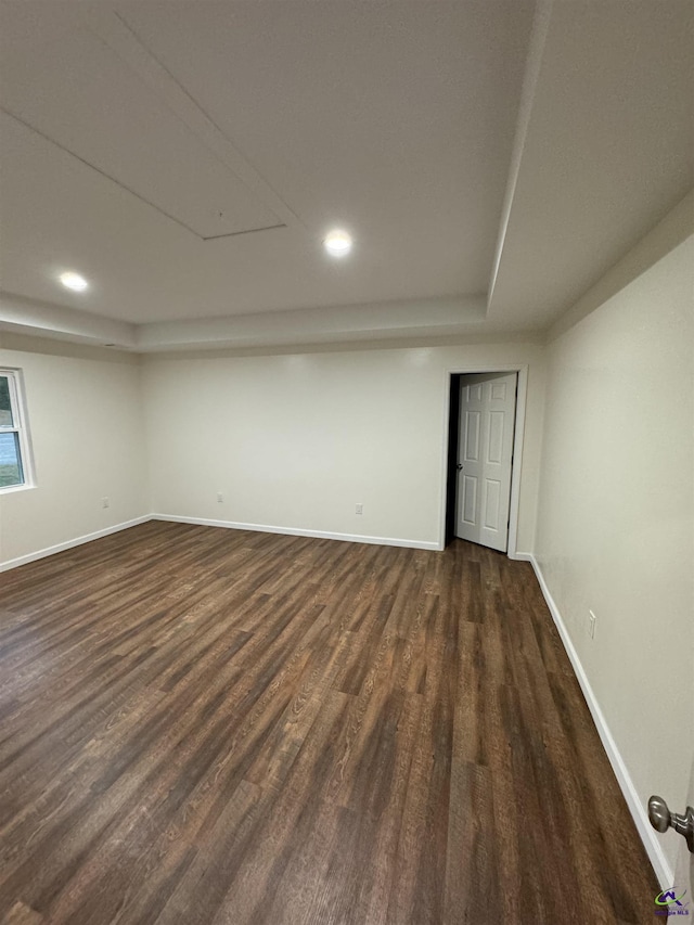 empty room with dark hardwood / wood-style flooring