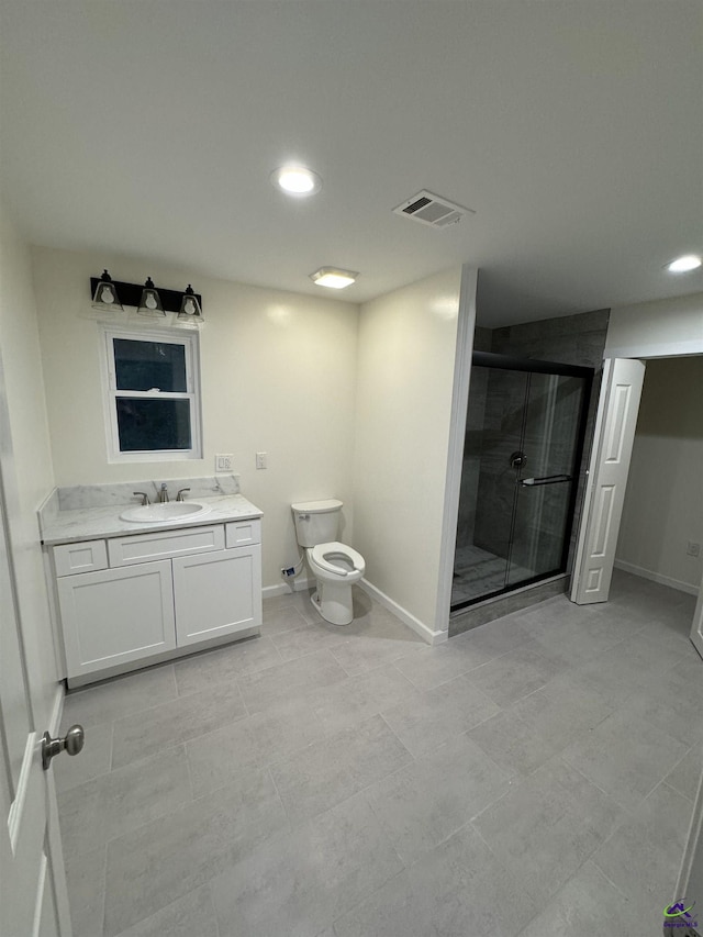 bathroom featuring vanity, toilet, and an enclosed shower