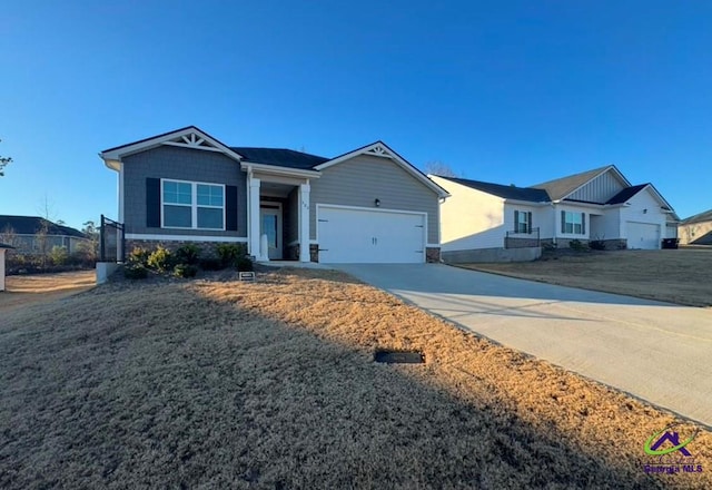 single story home featuring a garage and a front lawn