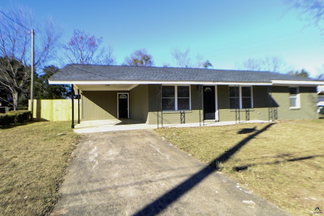 ranch-style house with a front yard and a carport