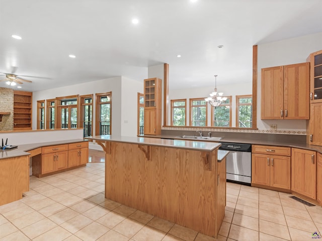 kitchen with a kitchen bar, kitchen peninsula, and stainless steel dishwasher