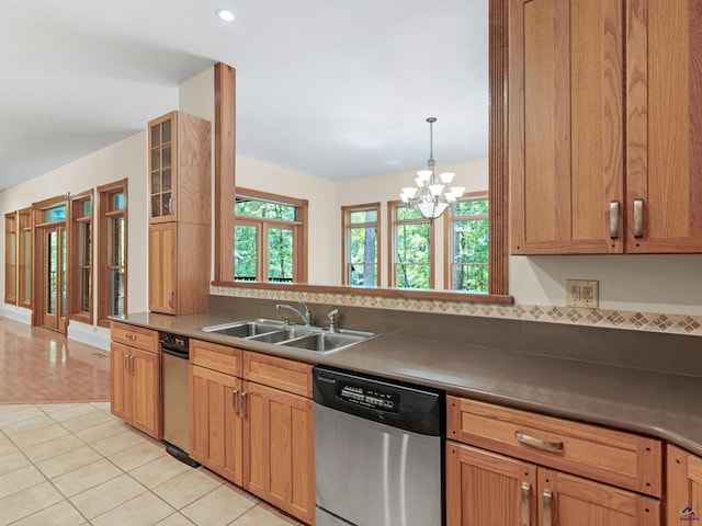 kitchen featuring dishwasher, sink, hanging light fixtures, an inviting chandelier, and light tile patterned flooring