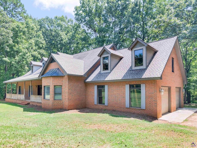 view of front of house featuring a front yard, a porch, and a garage