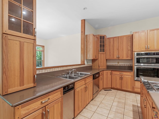 kitchen featuring sink, light tile patterned flooring, and appliances with stainless steel finishes