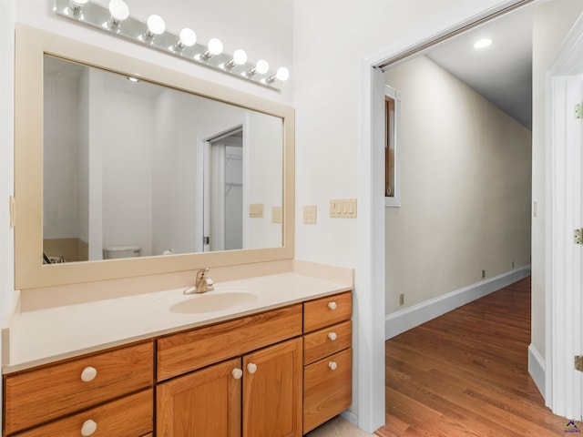 bathroom featuring hardwood / wood-style floors, vanity, and toilet