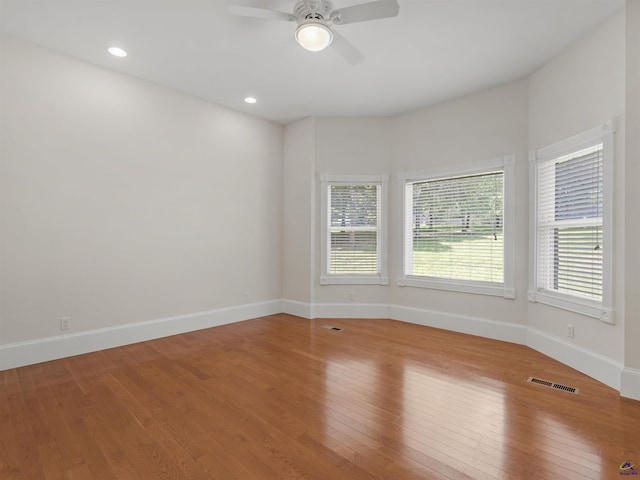 unfurnished room with hardwood / wood-style flooring and ceiling fan