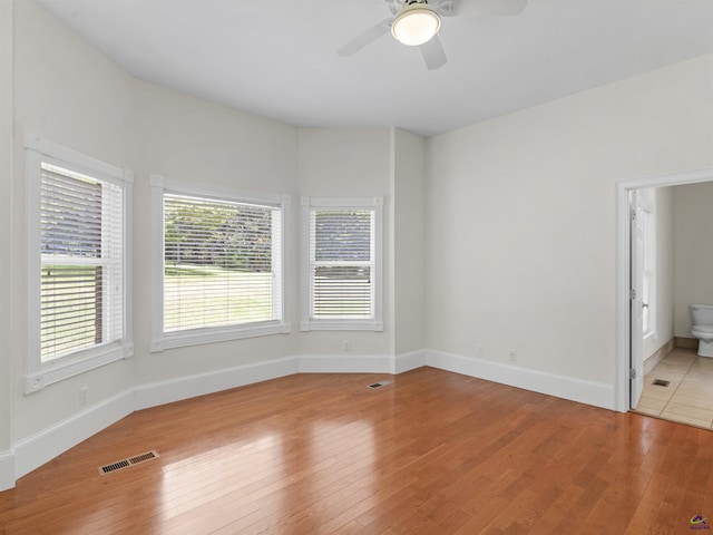 empty room featuring ceiling fan and light hardwood / wood-style flooring