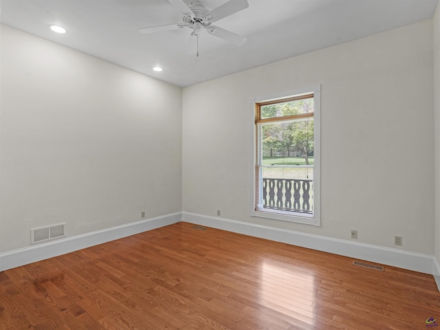 spare room featuring hardwood / wood-style floors and ceiling fan