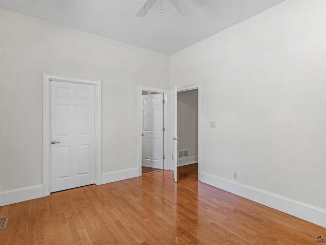 unfurnished bedroom featuring wood-type flooring and ceiling fan