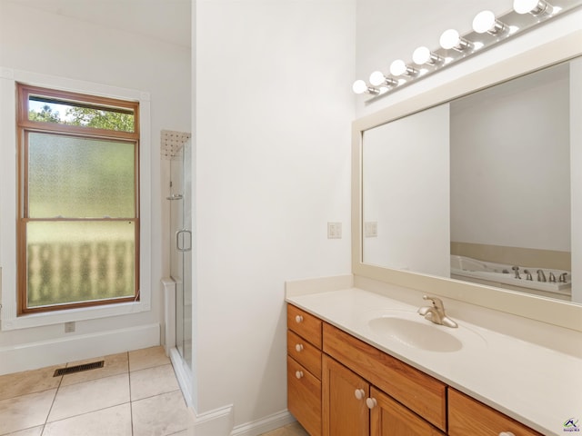 bathroom with tile patterned floors, vanity, and a shower with shower door