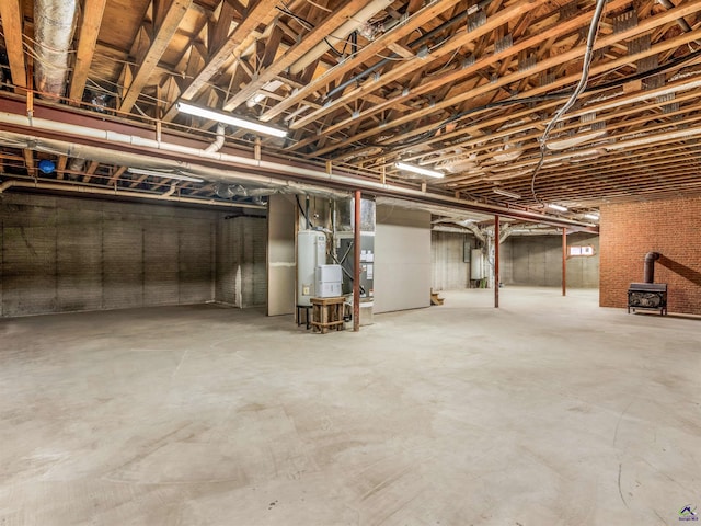 basement with a wood stove and water heater