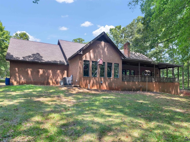 back of house with a lawn