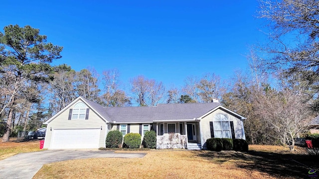 ranch-style home featuring a porch, a garage, and a front lawn