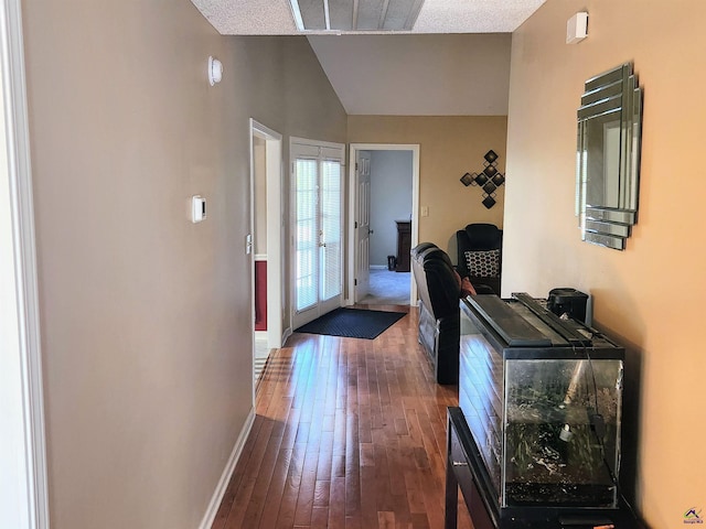 hall featuring a textured ceiling and dark hardwood / wood-style flooring