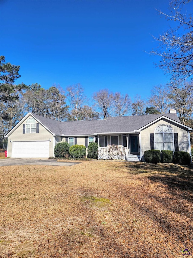 ranch-style house with a front yard and a garage