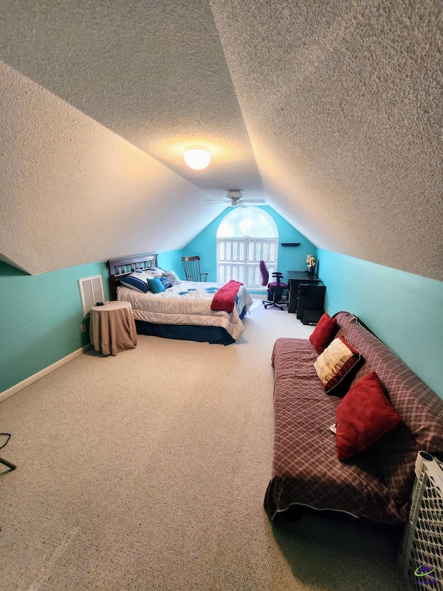 bedroom featuring carpet flooring, a textured ceiling, and lofted ceiling