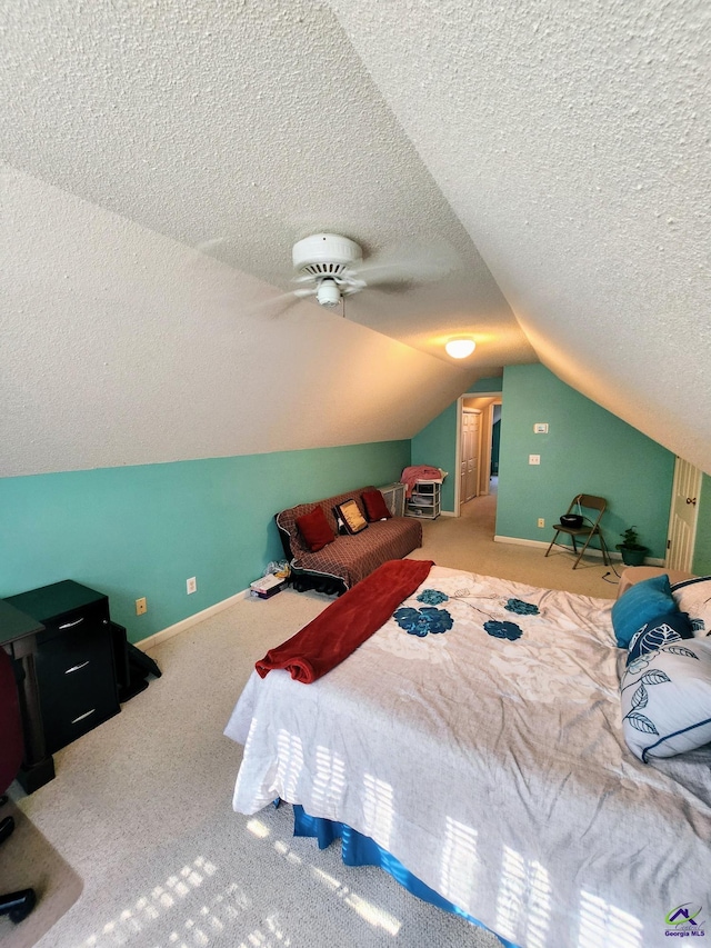 carpeted bedroom featuring a textured ceiling, ceiling fan, and lofted ceiling