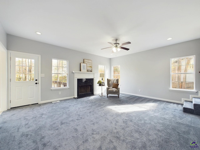 unfurnished room with carpet flooring and ceiling fan