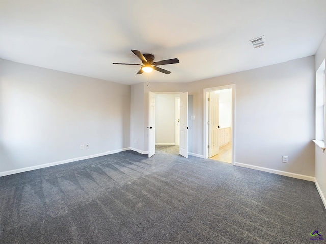 unfurnished room featuring ceiling fan and dark carpet