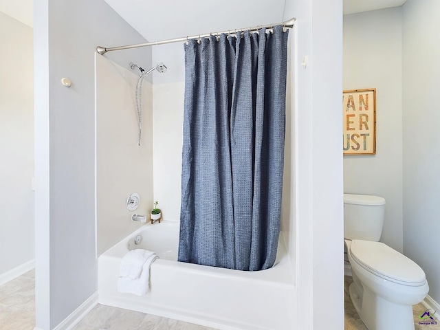 bathroom with shower / tub combo and toilet