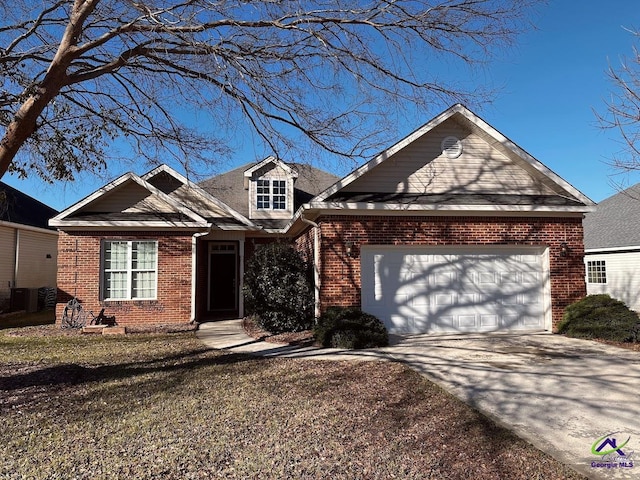 view of front of home featuring a front lawn, a garage, and cooling unit