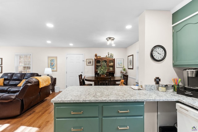 kitchen featuring dishwasher, light hardwood / wood-style floors, light stone counters, and green cabinets