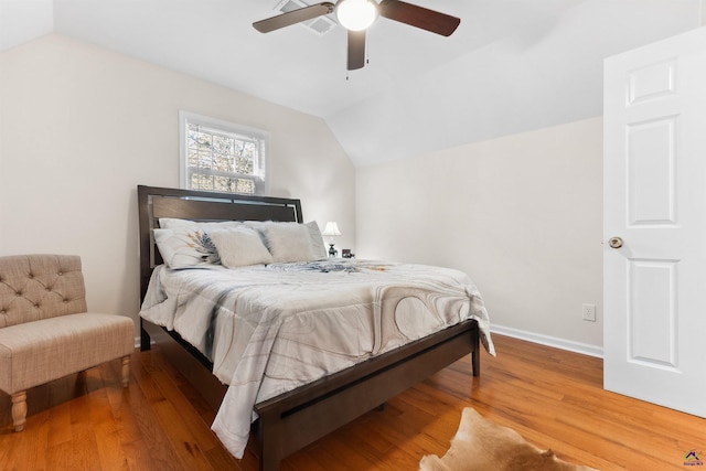 bedroom featuring ceiling fan, wood-type flooring, and lofted ceiling