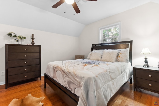 bedroom with wood-type flooring, ceiling fan, and lofted ceiling