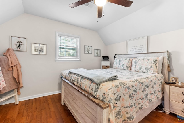 bedroom with ceiling fan, dark wood-type flooring, and vaulted ceiling