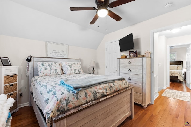 bedroom featuring ceiling fan, wood-type flooring, and vaulted ceiling