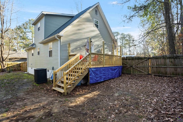 rear view of house featuring central AC and a deck