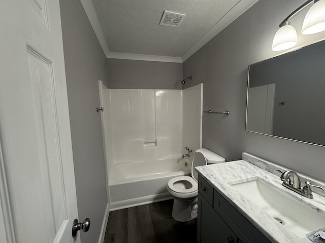 full bathroom featuring toilet, washtub / shower combination, wood-type flooring, a textured ceiling, and vanity