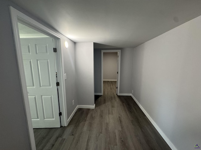 corridor with dark hardwood / wood-style floors