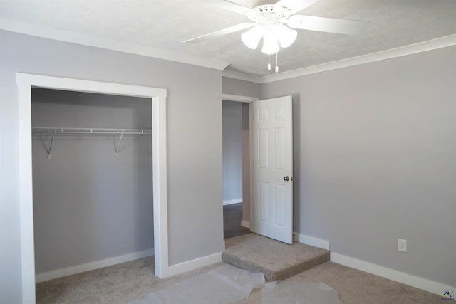 unfurnished bedroom with ceiling fan, ornamental molding, a closet, and light colored carpet