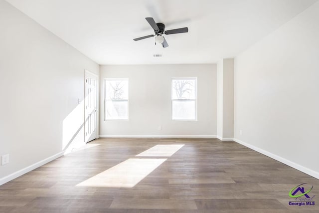 empty room featuring ceiling fan and hardwood / wood-style floors