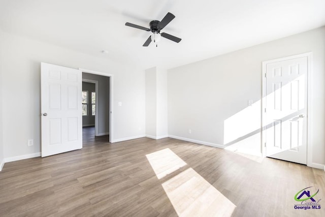 spare room with ceiling fan and light hardwood / wood-style flooring