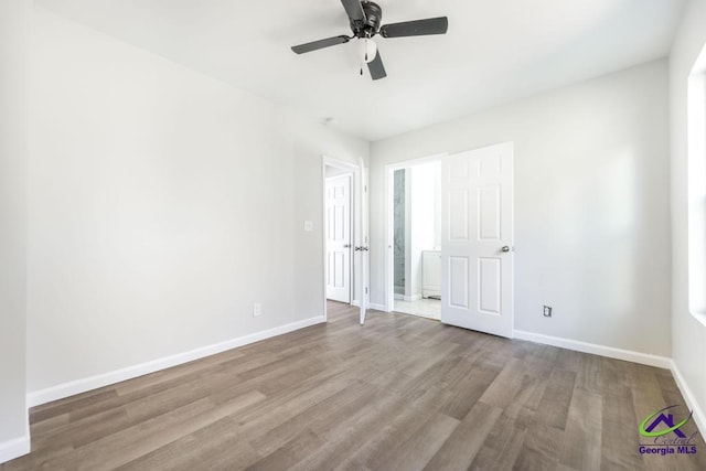 unfurnished bedroom featuring ceiling fan and light hardwood / wood-style flooring