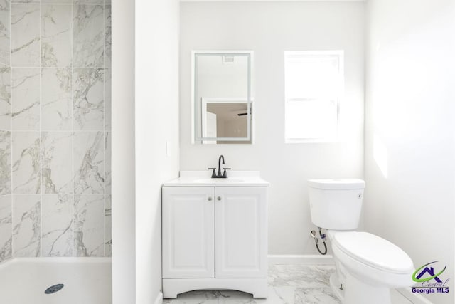 bathroom featuring vanity, toilet, and tiled shower